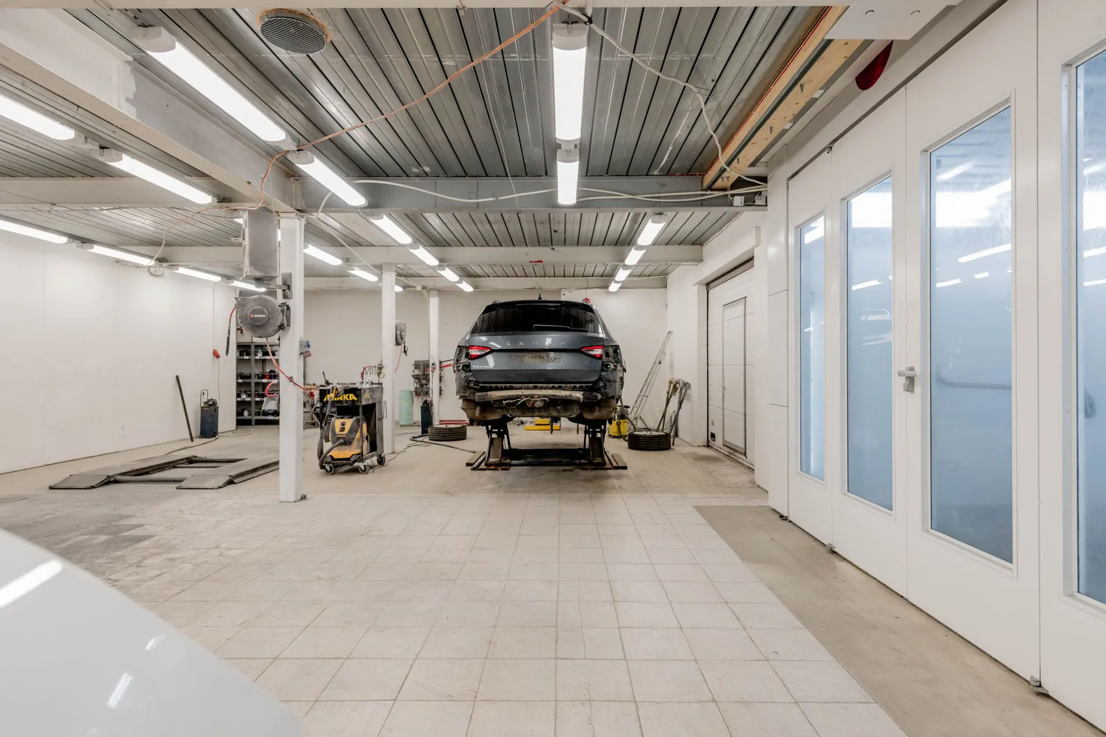 Well-lit automotive workshop service bays